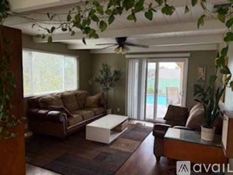 A living room with a brown couch and a white coffee table.