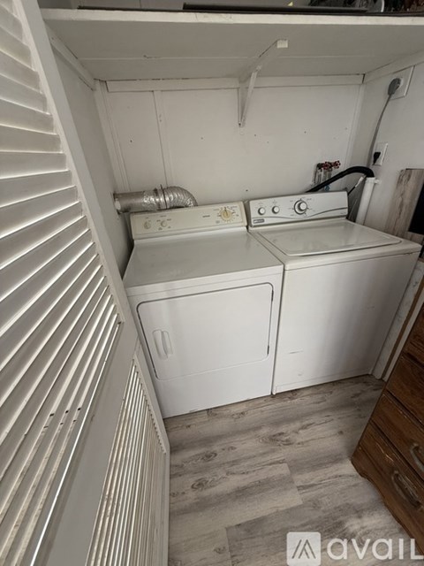 A small laundry room with a washer and dryer.