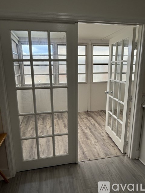 A room with a white door and a window.