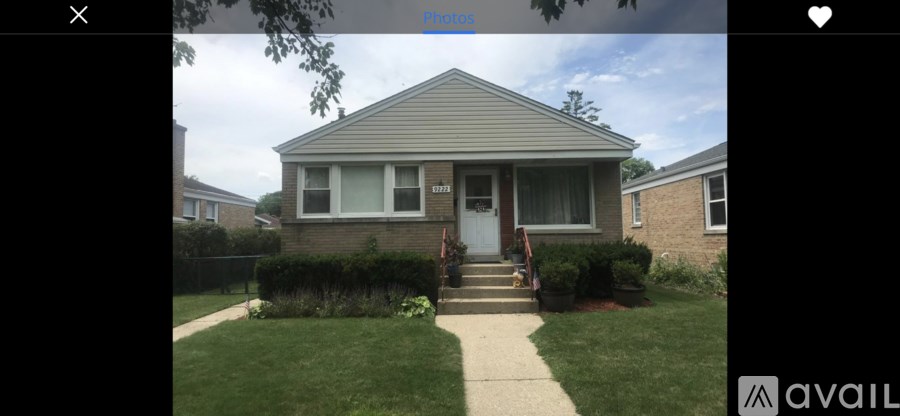 A house with a grey roof and a white door is shown.