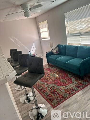 A room with a ceiling fan and a door leading to another room.