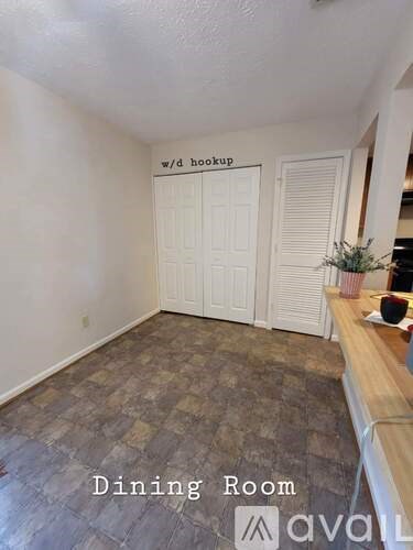 A dining room with a wooden table and chairs.