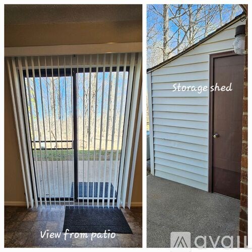 A storage shed with a brown door and a view from the patio with a black mat.