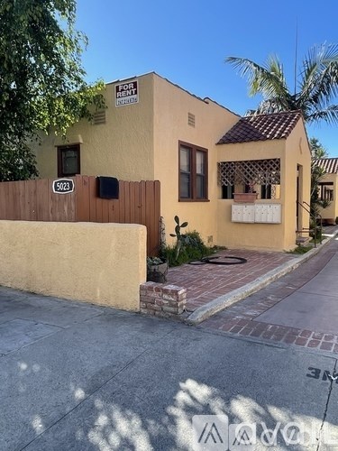 A yellow house with a sign that says "Fortune House" on it.