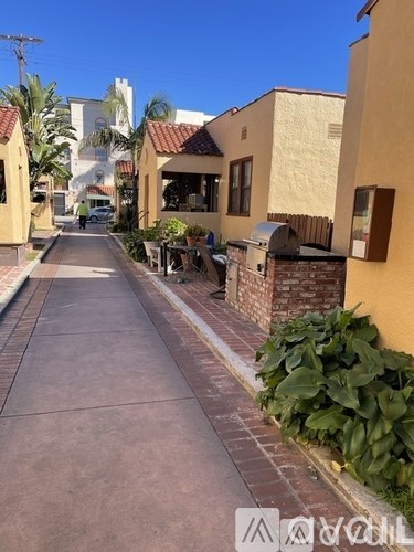 A street with a sidewalk and a few buildings.