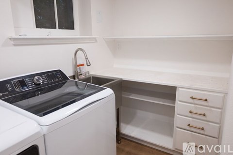 A kitchen area with a refrigerator, oven, and microwave.