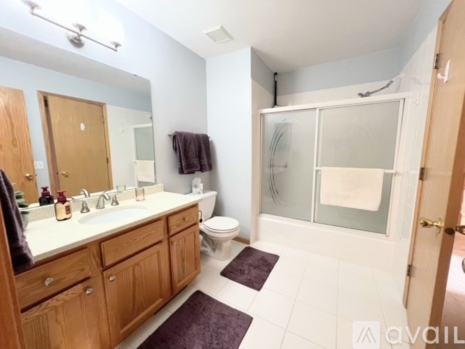 A bathroom with a toilet, sink, and shower.