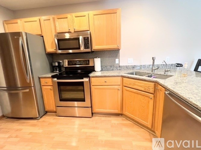 A kitchen with wooden cabinets and stainless steel appliances.