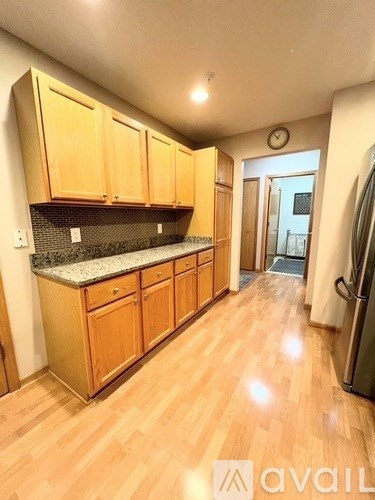 A kitchen with wooden cabinets and a granite countertop.