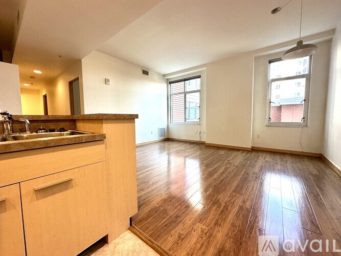 A kitchen with wooden floors and a counter top.