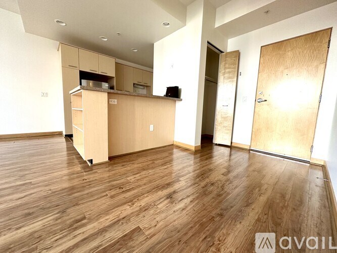 A kitchen with wooden floors and cabinets is available for rent.