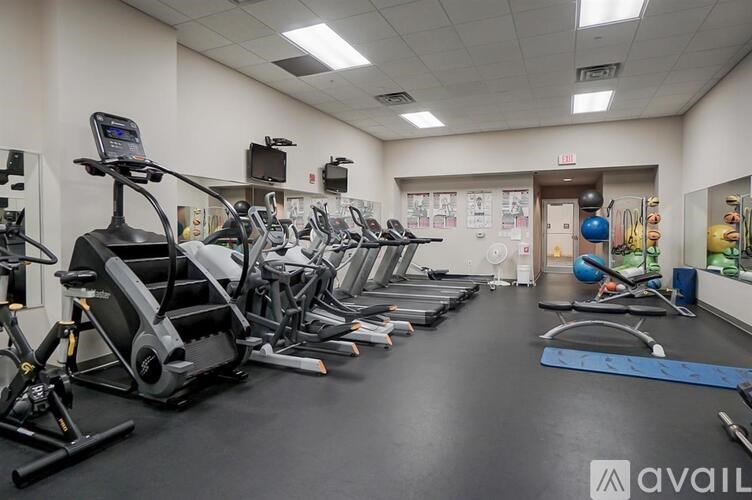 A gym with treadmills, exercise bikes, and other equipment.