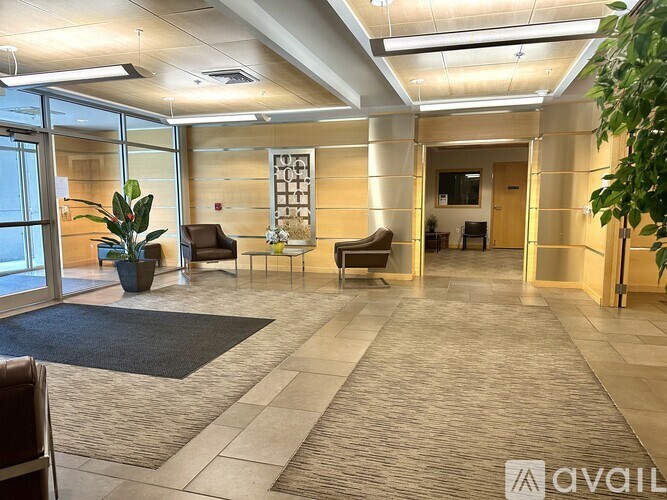 A spacious office lobby with a reception desk and chairs.