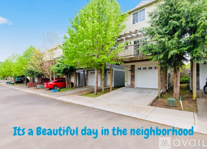 A beautiful day in the neighborhood with a red car parked on the street.