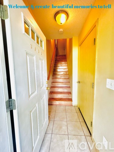 A hallway with a white door on the left and a yellow door on the right.