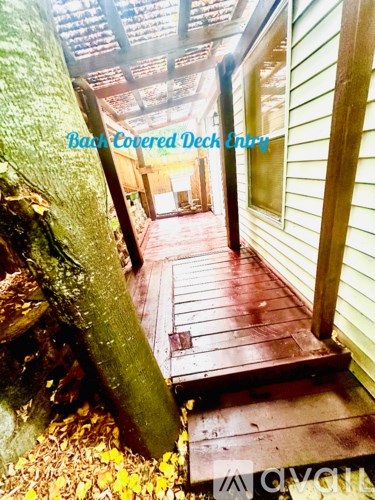 A wooden deck is covered with a green tarp.