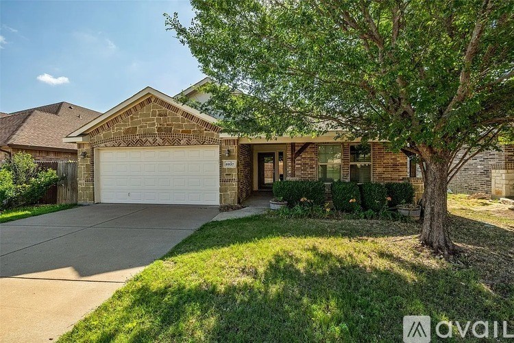 A house with a tree in front of it.