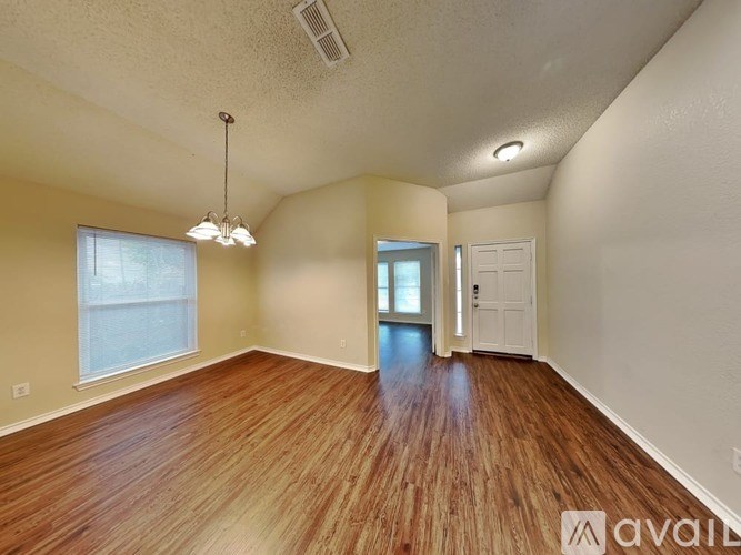A room with wooden floors and a white door.