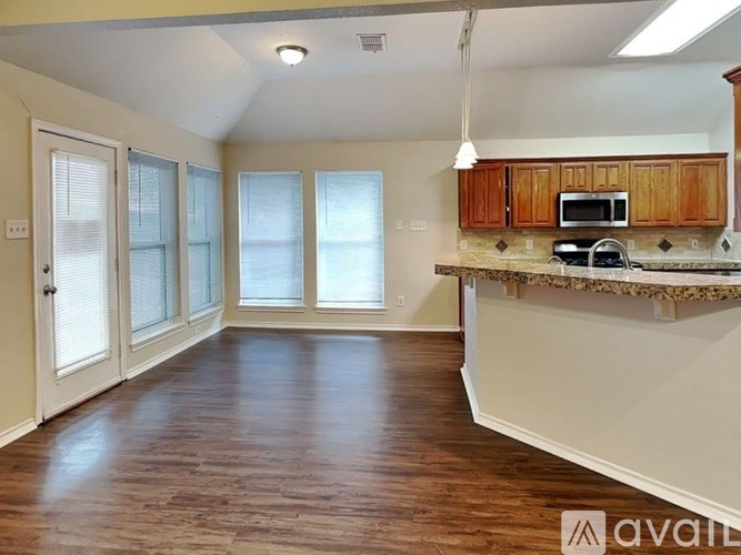 A kitchen with wooden cabinets and a countertop.