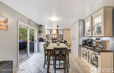 A kitchen with a table and chairs in the middle of the room.