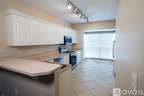 A kitchen with white cabinets and a counter.
