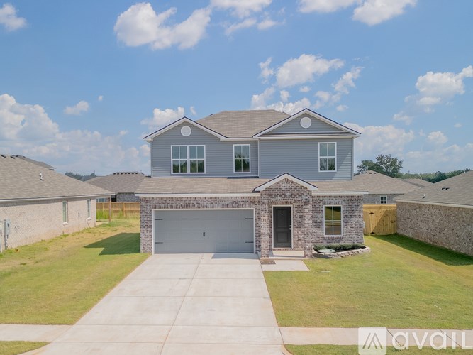 A house with a grey roof and a garage door.
