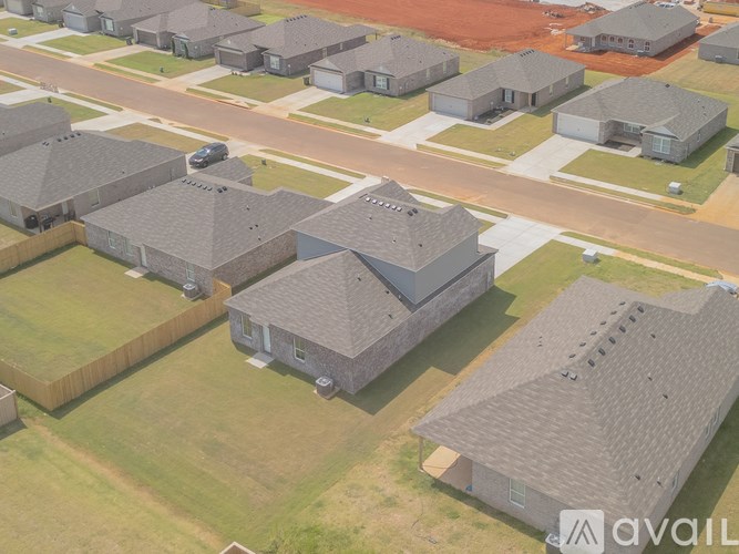 A bird's eye view of a residential area with houses and roads.