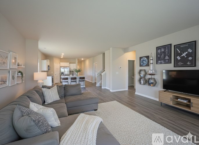A living room with a grey couch and a television.