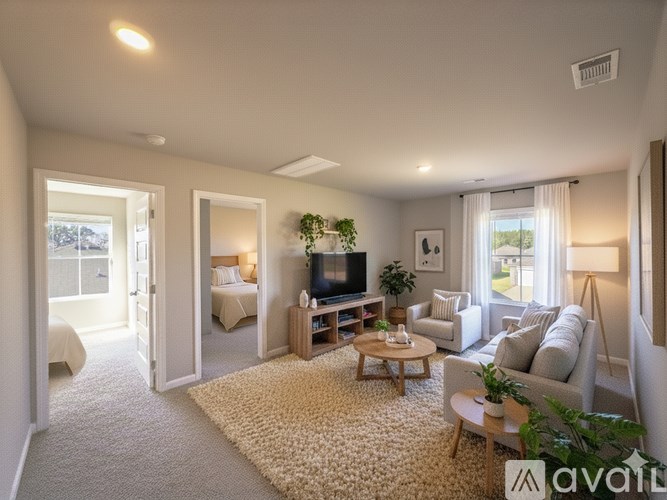 A living room with a flat screen TV and a couch.
