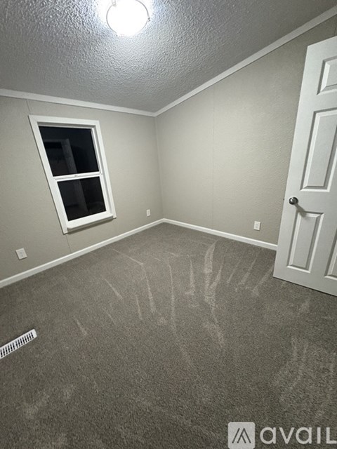 A room with a window and a door.