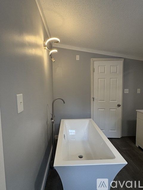 A white bathroom sink with a white door in the background.