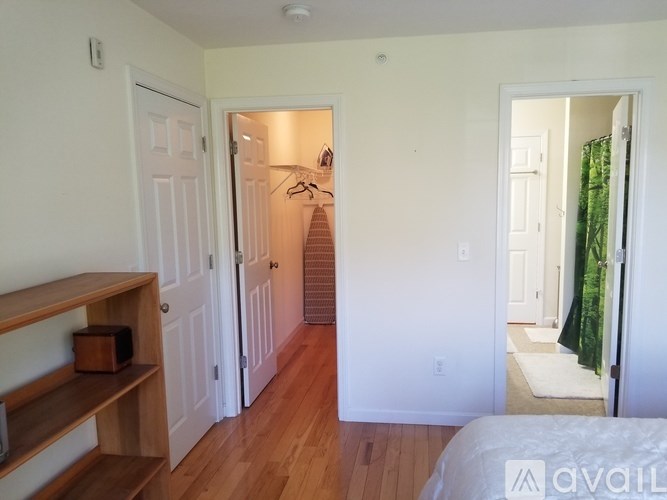 A room with a wooden floor and white walls.