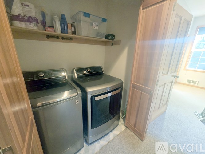 A small laundry room with a washer and dryer.