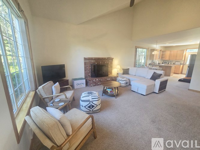 A living room with a fireplace and a flat screen TV.