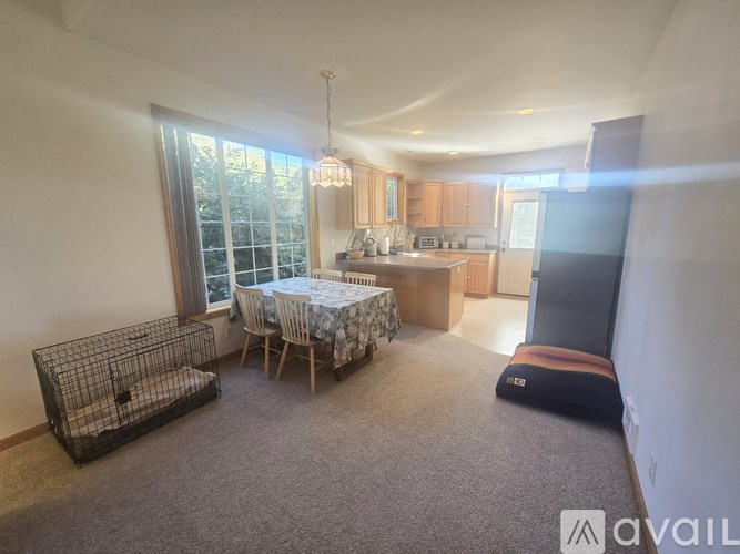A well-lit kitchen and dining area with a table set for four.