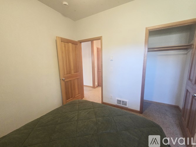 A bedroom with a bed and a door.