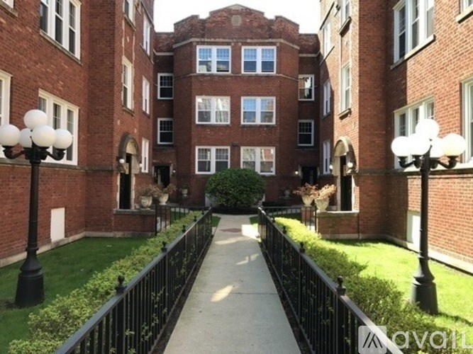 A brick building with a walkway in front.