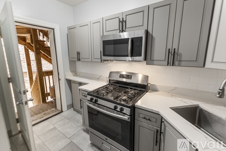 A kitchen with a stove, oven, and microwave.