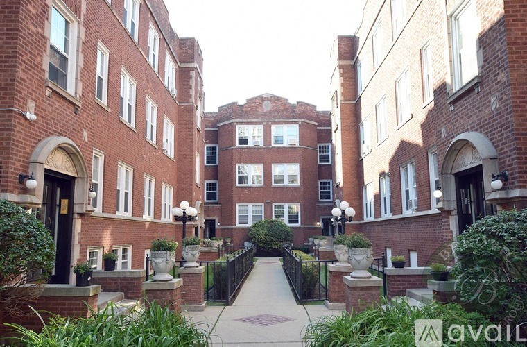 A brick building with a gate in front.