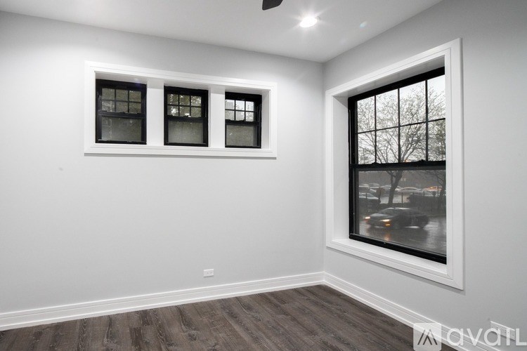 A room with a window and a ceiling fan.