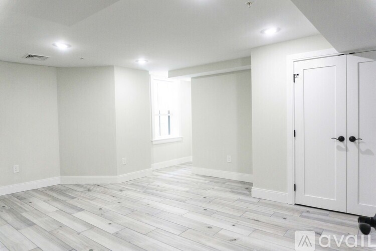A room with a wooden floor and white walls.