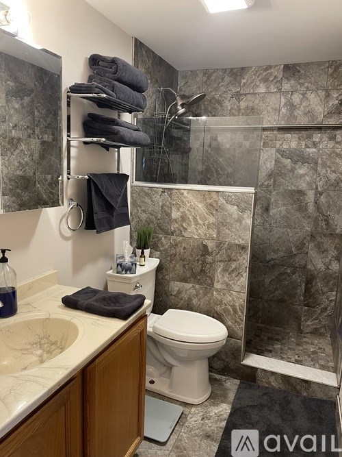 A room with a desk, chair, and a cabinet.