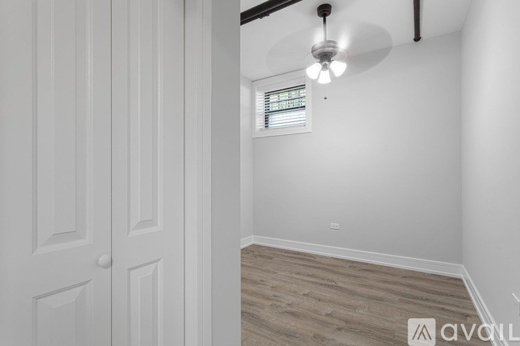 A room with a white door and a window with blinds.