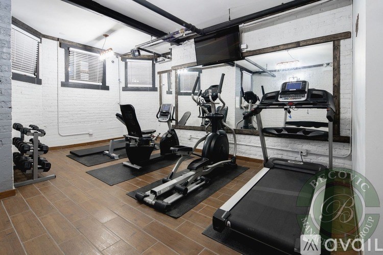 A gym with treadmills, weights, and exercise equipment.