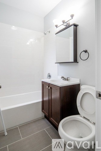 A white toilet sits next to a sink in a bathroom.