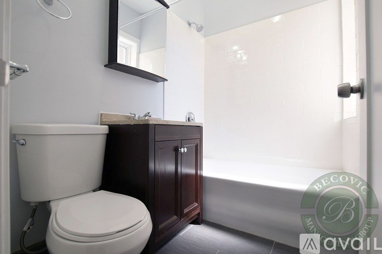 A white toilet sits next to a sink in a bathroom.