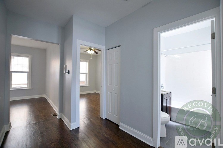 A spacious room with a toilet visible through the open door.