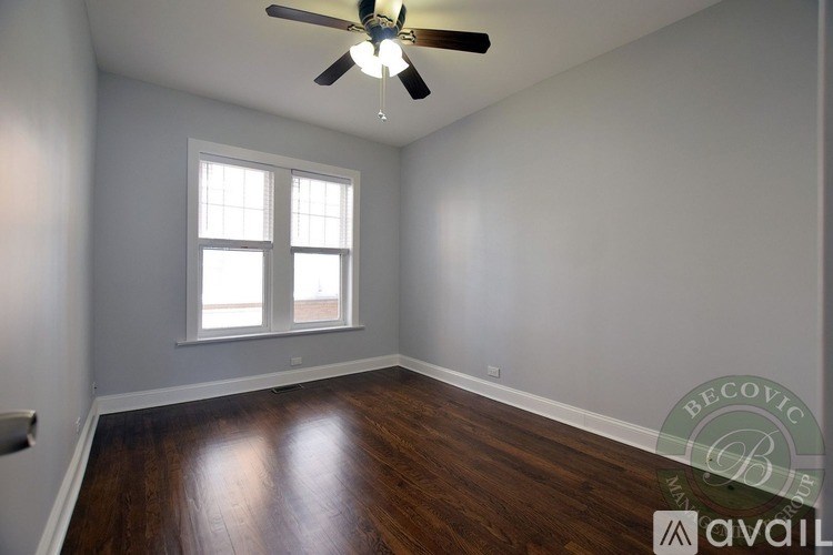 A room with a ceiling fan and a window.