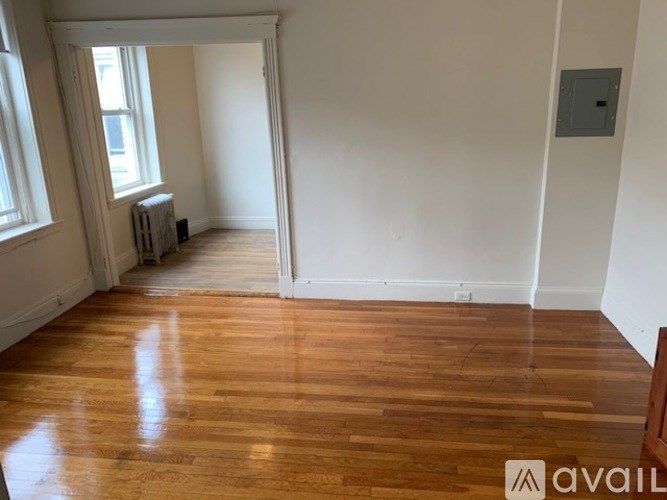 A room with wooden floors and white walls.