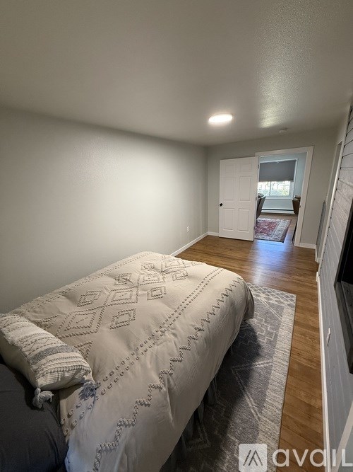 A bedroom with a bed and a window.